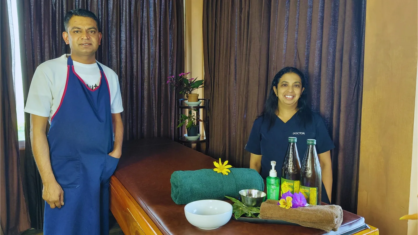 Two people standing beside a table in an interior room at The Mist.