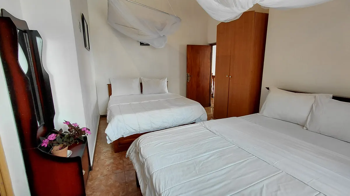 Family Room at The Mist with two double beds and wood furniture.