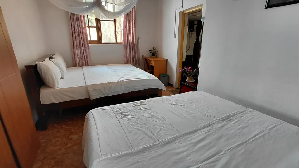 Two double beds viewed towards the window in the Family Room at The Mist.