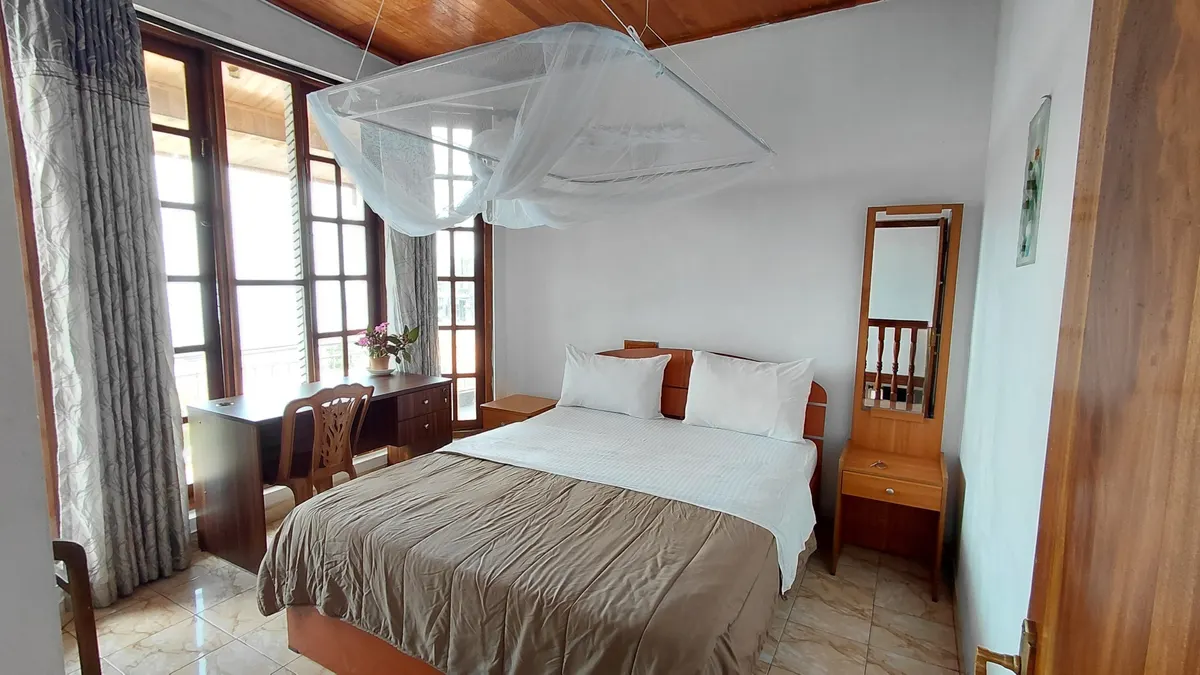 Representative Standard Double Room at The Mist with wood furniture.