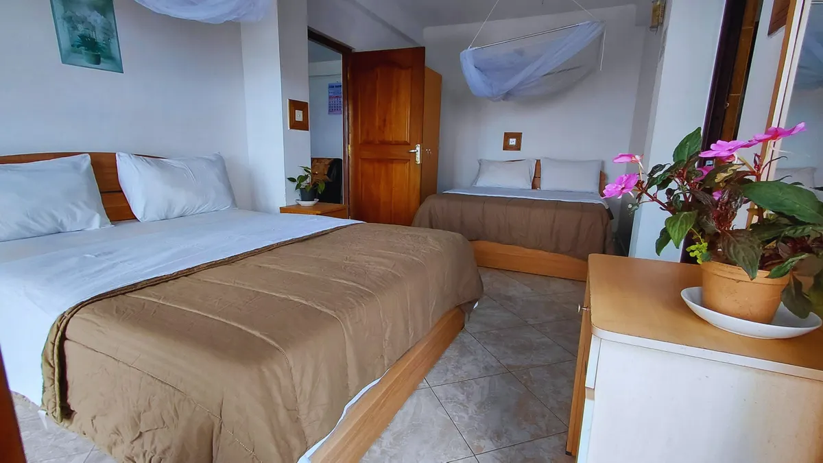Two double beds in Super Deluxe Family Room 106 at The Mist.
